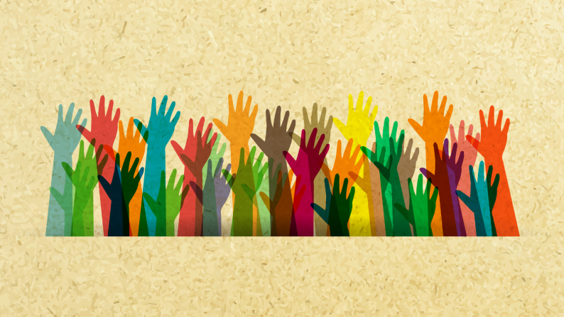 Collection of different coloured hands raised up