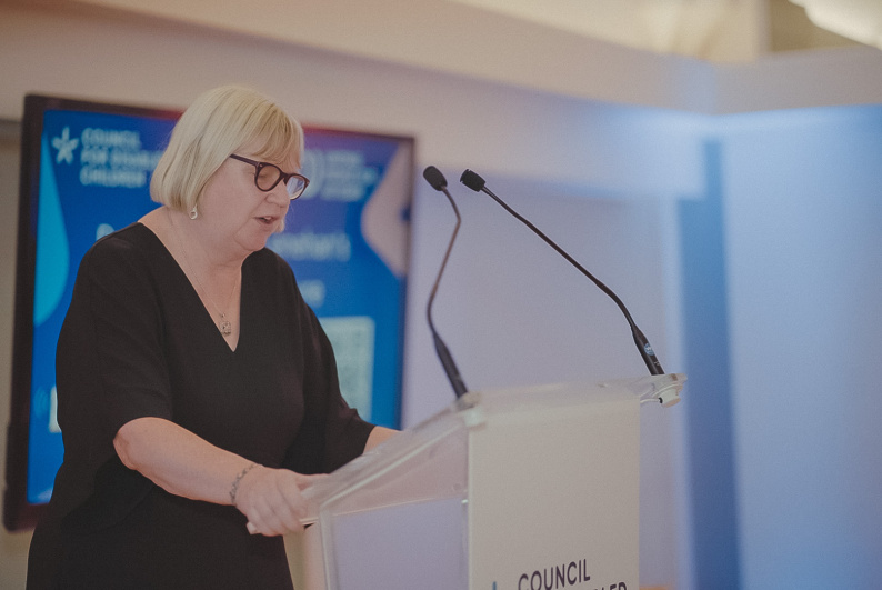 Dame Christine Lenehan speaking in front of an audience