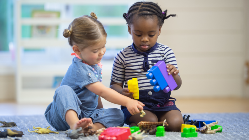 Two children playing with blocks