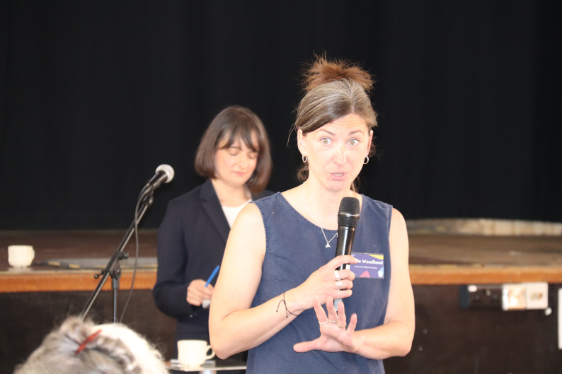 Woman talking with microphone at an event 