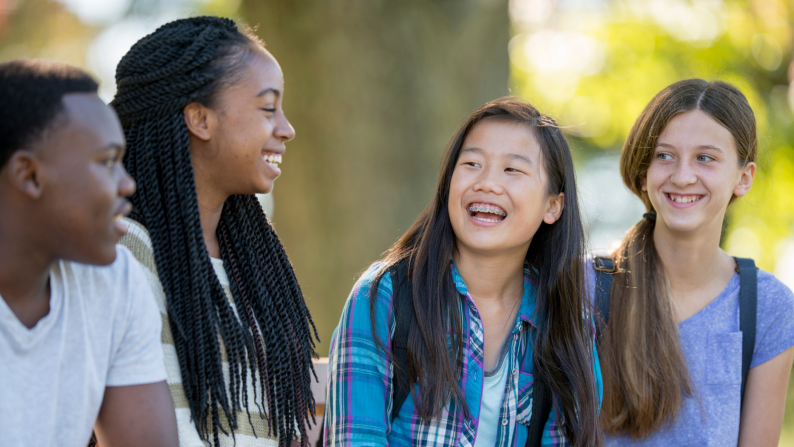 Group of four young people smiling