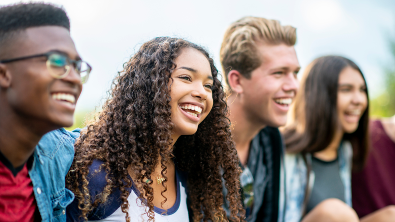 Group of four young people smiling