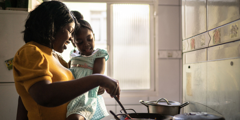 Mother and daughter cooking in kitchen