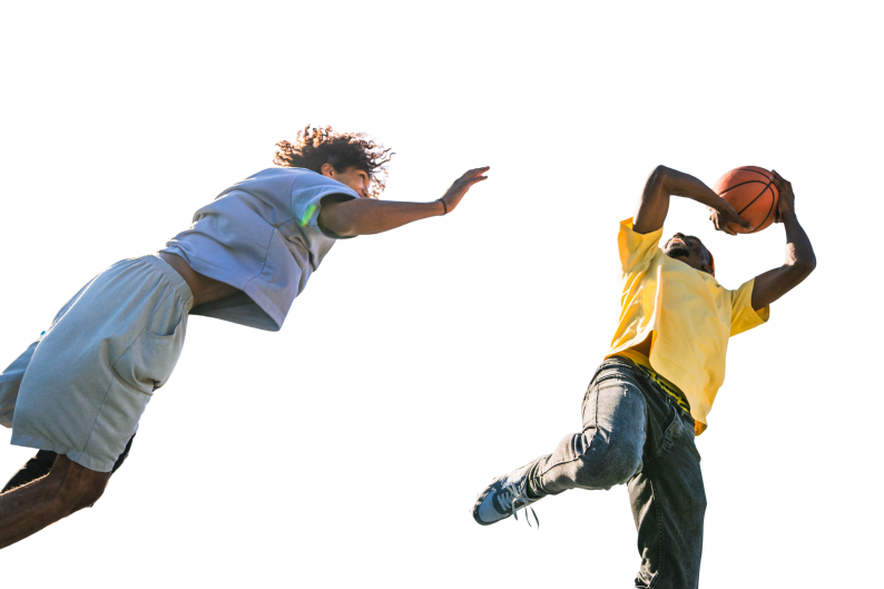 Two teenagers playing basketball viewed from below
